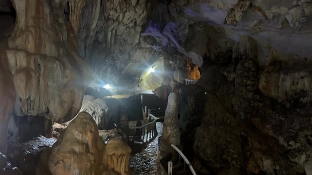 Wang Vieng, Laos.Tham Jang Cave-stalactites and stalagmites in a karst mountain with a Buddha temple inside. There is a spring inside the cave. The cave is equipped with comfortable paths and lanterns