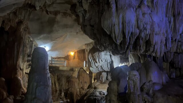 Wang Vieng, Laos.Tham Jang Cave-stalactites and stalagmites in a karst mountain with a Buddha temple inside. There is a spring inside the cave. The cave is equipped with comfortable paths and lanterns