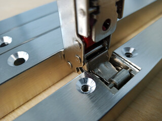 aluminum facade profile with inset hinge holes. furniture parts in production.