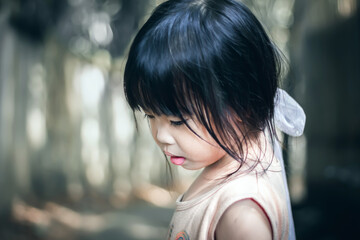 Portrait of a beautiful little asian girl in the park.