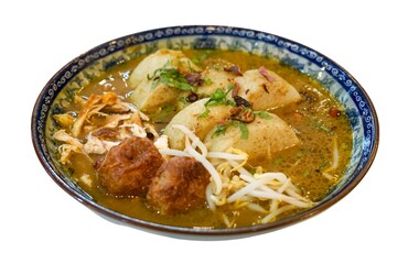 Authentic Soto Ayam served in a decorative bowl with shredded chicken, potatoes, bergedil, bean sprouts, and garnishes in rich chicken broth.