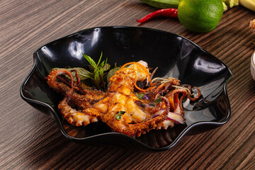 Gourmet grilled whole octopus served lime