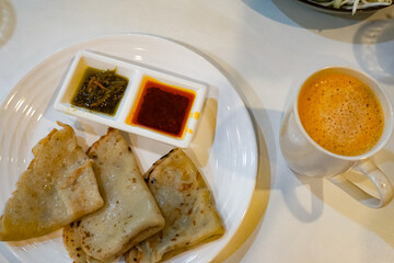 Lempeng (Pancakes) with Red and Green Sambal on White Plate