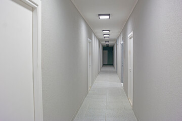 Finished Corridor Along With Line Square Ceiling Lamps in the Newly Built Apartment Building.