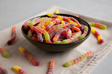 Sugary Sour Gummy Worms in a Bowl, side view.