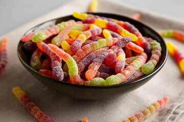 Sugary Sour Gummy Worms in a Bowl, side view.
