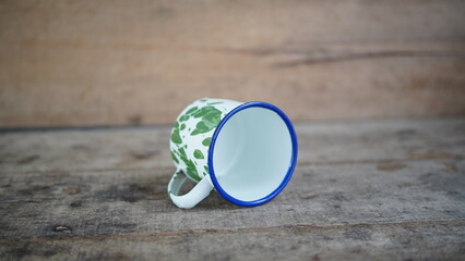 A classic patterned aluminum cup with vintage design, showing metallic texture and elegant craftsmanship. Perfect for retro or kitchen-themed concepts