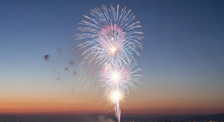 Vibrant, colorful fireworks burst in a gradient sky. Display of light and smoke against the twilight