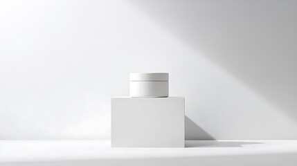 Minimalist product display of a white cosmetic jar on a white cube with natural light and shadows, ideal for beauty, skincare, and clean branding.