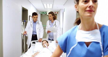 Rushing staff in scrubs and coats transporting child on gurney down hospital corridor with IV pole