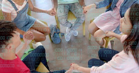 Holding hands five peers forming support circle on plastic chairs in classroom, with blue backpack
