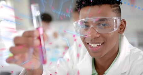 African American teen wearing lab coat holding pink test tube at school lab, with digital overlay