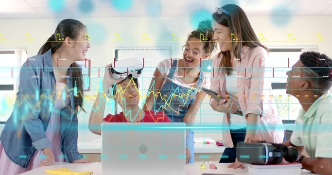 Holding VR headset, teenage boy in red T-shirt sharing demo in lab with laptop and markers