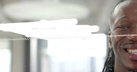 Smiling man with dreadlocks wearing dark top facing camera in office, waveform overlay, copy space