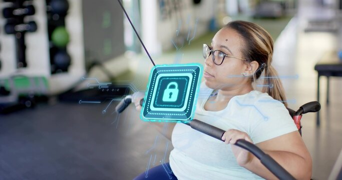 Gripping wheelchair user in blue tee and glasses at gym, pulling cable bar with holographic lock - Powered by Adobe