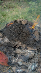 Burning dry trash with flames and smoke outdoors