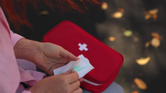 First aid kit. Park bench. Woman sitting. slow motion video. High quality 4k footage
