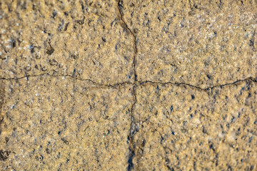 Abstract background of a rock with a crack dividing it into square parts
