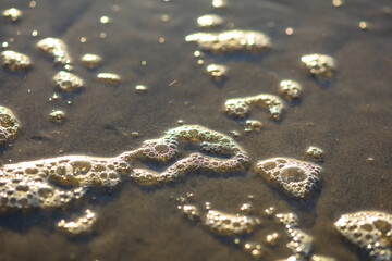 Abstract background with water, sand and wave foam
