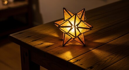 Decorative star lantern glowing warmly on a rustic wooden table surface indoors