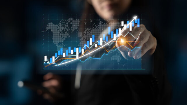 A business professional engages with a futuristic financial graph that portrays growth trends and data analysis while holding a smartphone in a modern office setting. Impute