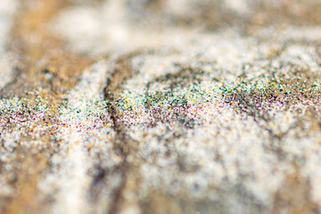 Yellow and red lines on a sandy surface, macro
