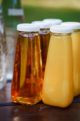 Refreshing juices in glass bottles outdoors