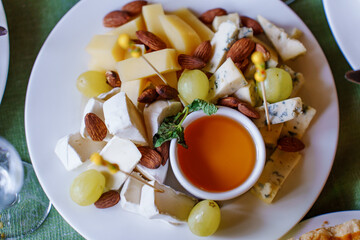 Cheese and fruit platter with nuts and honey dipping sauce
