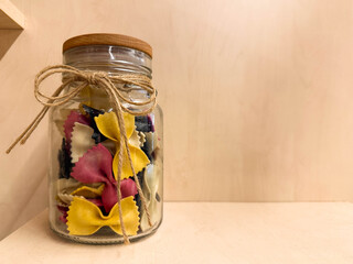 A jar of craft colorful pasta made from natural ingredients	
