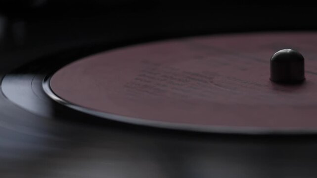 macro vinyl record spinning in turntable, vintage vinyl record playing music