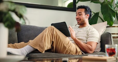 Tablet, happy and man on video call on sofa in home for communication, networking or connectivity. Relax, technology and male person on virtual conversation for contact in living room at apartment. - Powered by Adobe