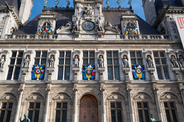 The stunning City Hall of Paris, France showcases intricate architecture. Colorful flags hang from the facade, adding vibrancy to the historic structure