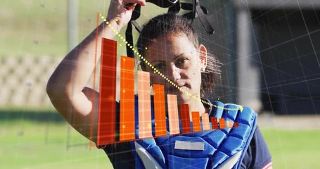 Female catcher fastening protector, removing helmet, revealing sports analytics bar chart - Powered by Adobe