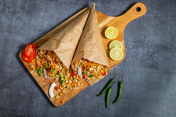 "Jhalmuri", a spicy Bengali street snack made with puffed rice, mustard oil, onions, chilies, and tangy spices for crunch and flavor.
