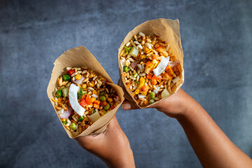 "Jhalmuri", a spicy Bengali street snack made with puffed rice, mustard oil, onions, chilies, and tangy spices for crunch and flavor.
