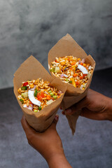 "Jhalmuri", a spicy Bengali street snack made with puffed rice, mustard oil, onions, chilies, and tangy spices for crunch and flavor.
