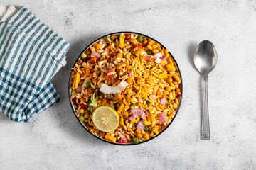 "Jhalmuri", a spicy Bengali street snack made with puffed rice, mustard oil, onions, chilies, and tangy spices for crunch and flavor.
