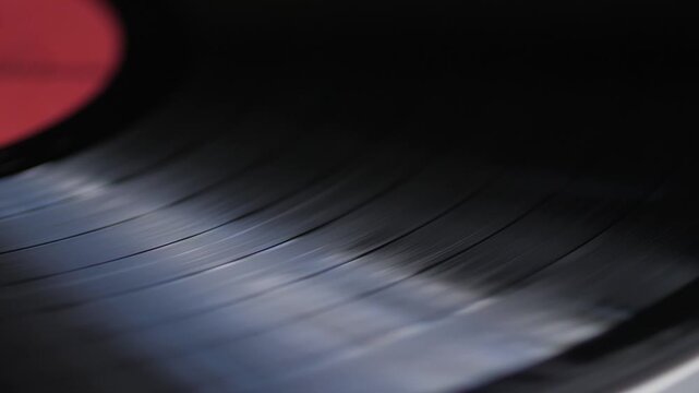  close-up of a vinyl record spinning, vintage gramophone record in player, macro vinyl record texture