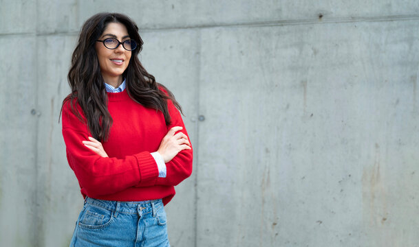 Smiling friendly confident woman in formal wear with crossed arms 