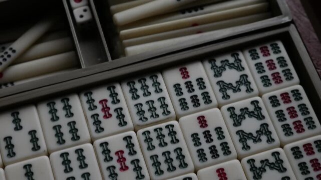 Traditional Mahjong Tiles Set with Circle Dots and Bamboo Sticks Arranged in Wooden Box