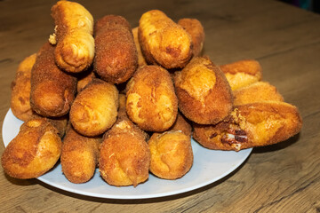 Golden‑Fried Pirozhki Pastries Stacked on White Plate Close‑up of homemade Eastern European pirozhki