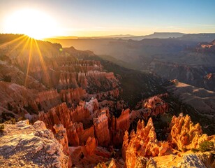 Scenic canyon vista at sunset with radiant sun rays over rock formations