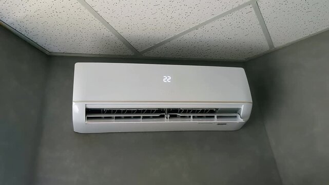 air conditioner unit displaying digital temperature change in modern office interior