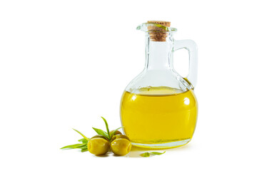 Extra virgin olive oil in a transparent jug and green olives with leaves.