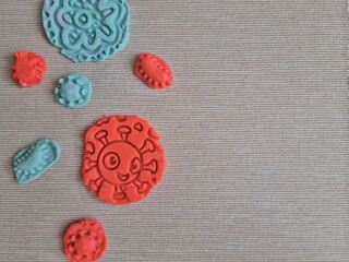 Covid and other respiratory virus molecules made of plasticine. Little toddler education moment in a playful mode. Bacteria made of playdough.