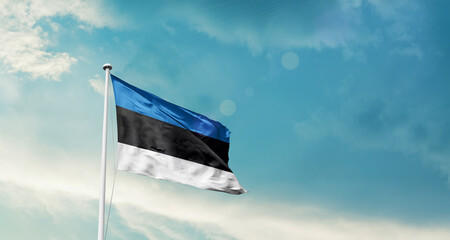 Estonia national flag fluttering. The flag blowing in beautiful soft sky. Estonia national flag for independence day.