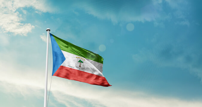 Equatorial Guinea national flag fluttering. The flag blowing in beautiful soft sky. Equatorial Guinea national flag for independence day.