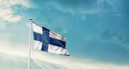 Finland national flag fluttering. The flag blowing in beautiful soft sky. Finland national flag for independence day.
