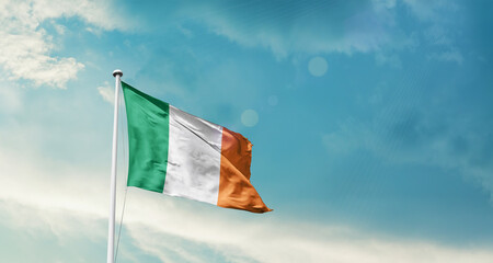 Ireland national flag fluttering. The flag blowing in beautiful soft sky. Ireland national flag for independence day.