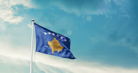 Kosovo national flag fluttering. The flag blowing in beautiful soft sky. Kosovo national flag for independence day.